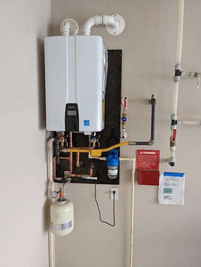 Professional plumber installing copper piping in a Dearborn home